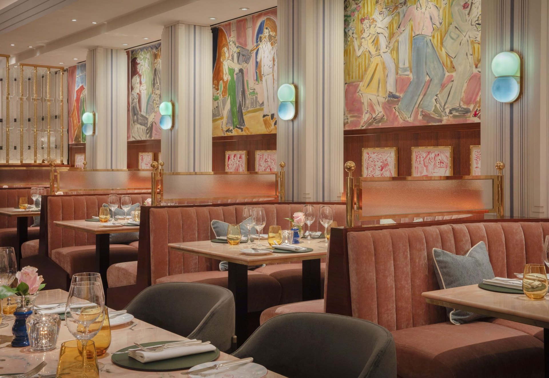 Velvet banquettes beneath painted murals at Le Magritte