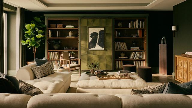 A residents’ lounge at Chelsea Barracks with deep sofas, bookshelves and a chessboard